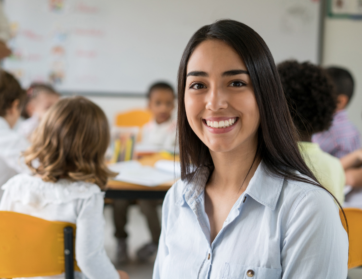 Portrait of a happy Latin American teacher smiling