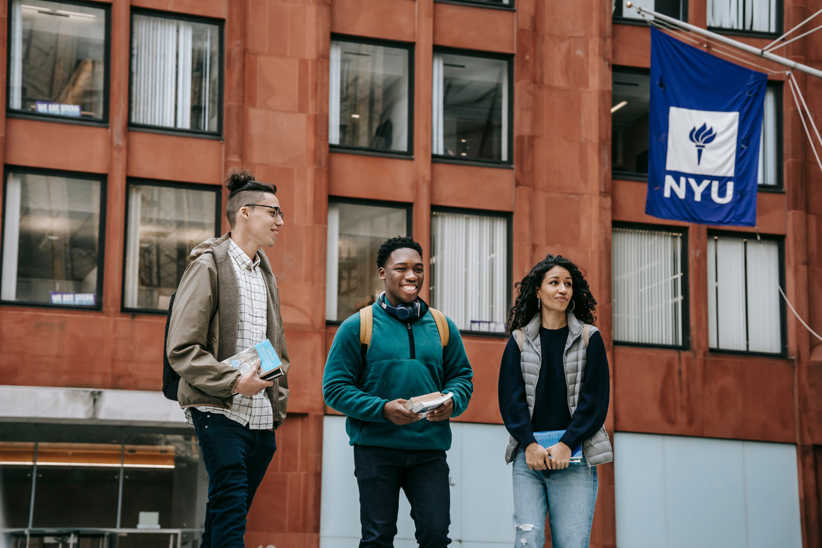 Diverse groupmates walking near university