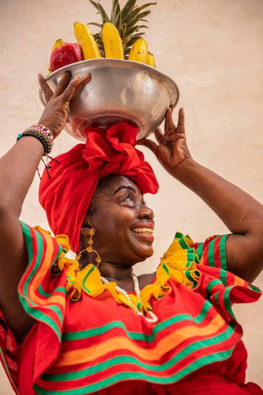 Portrait of Smiling Woman Carrying Bowl of Fruits 