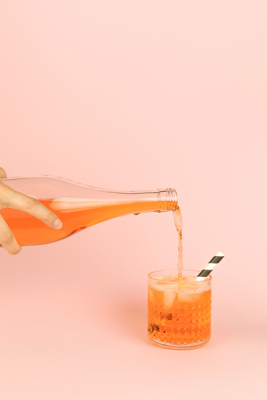 Spritz Being Poured into a Glass with Straw 