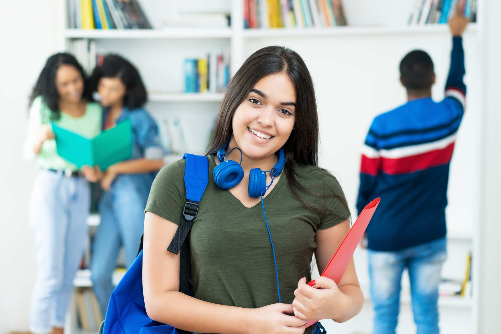 Laughing spanish female student with group of students