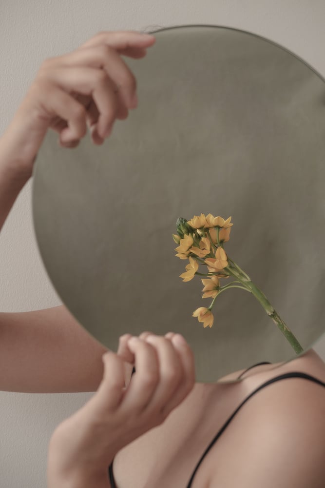 Woman Holding Round Mirror