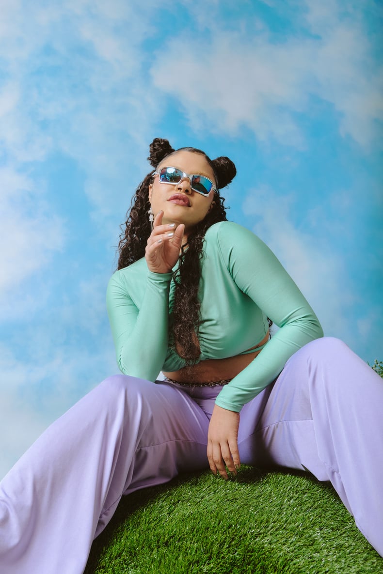 Stylish Young Woman Sitting on the Grass