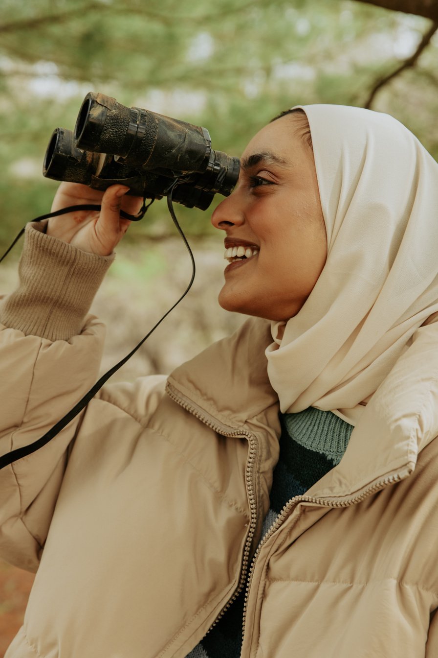 Woman Birdwatching in the Woods