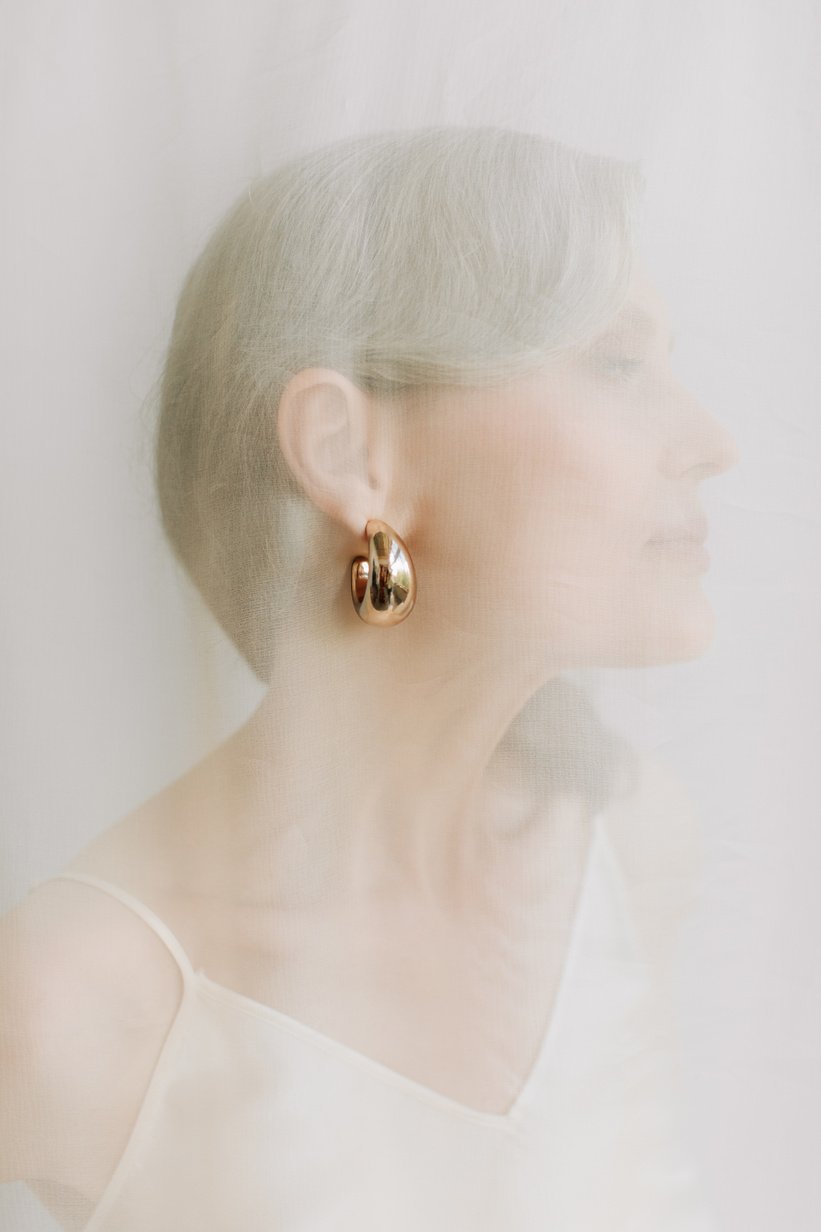 Portrait of a Mature Woman in Gold Earring