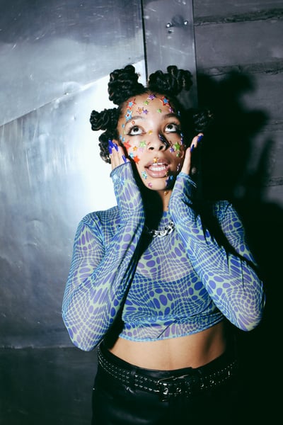 Woman in Dreadlocks with Sheer Top and Face Stars Confetti