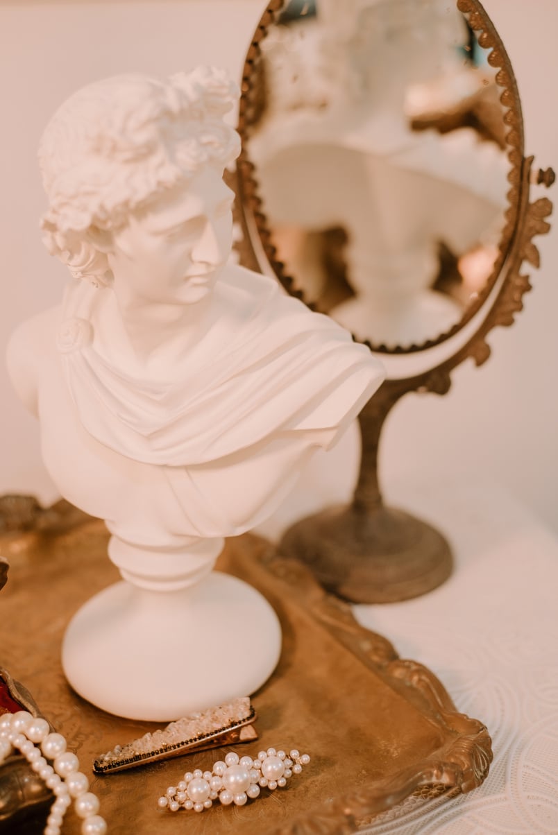 Vintage Mirror, Statue, and Hair Accessories on a Tray