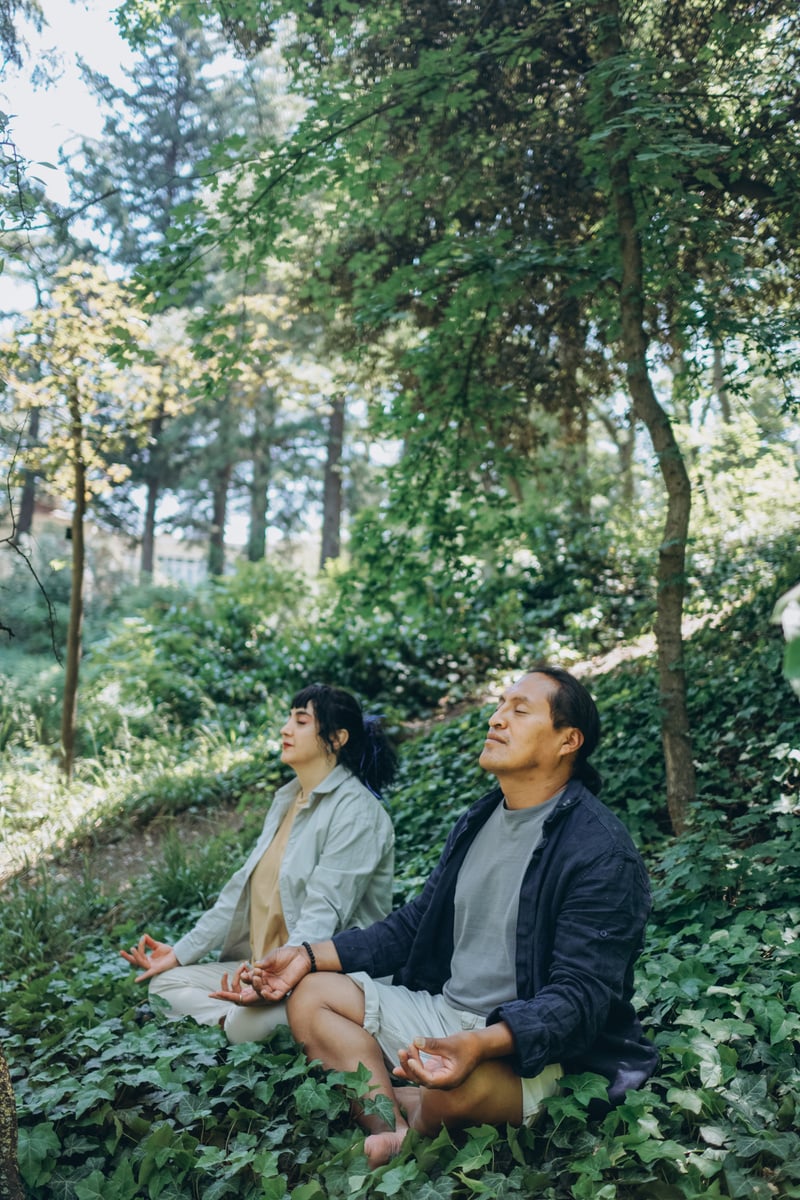 Man and Woman Meditating in the Forest