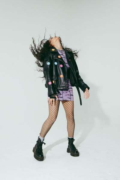 Woman in Purple Dress, Leather Jacket and Fishnet Stockings 