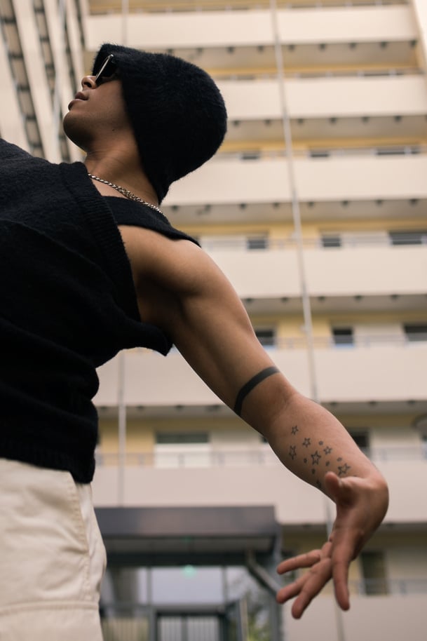 Man Dancing Outside an Apartment Building