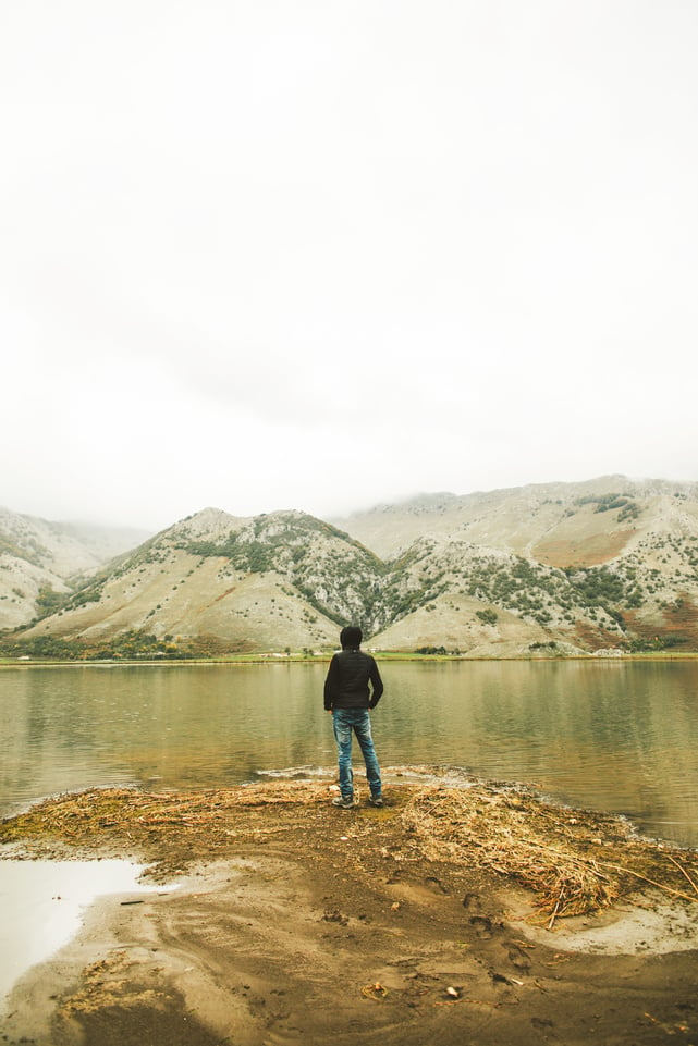 Man Standing on Lake